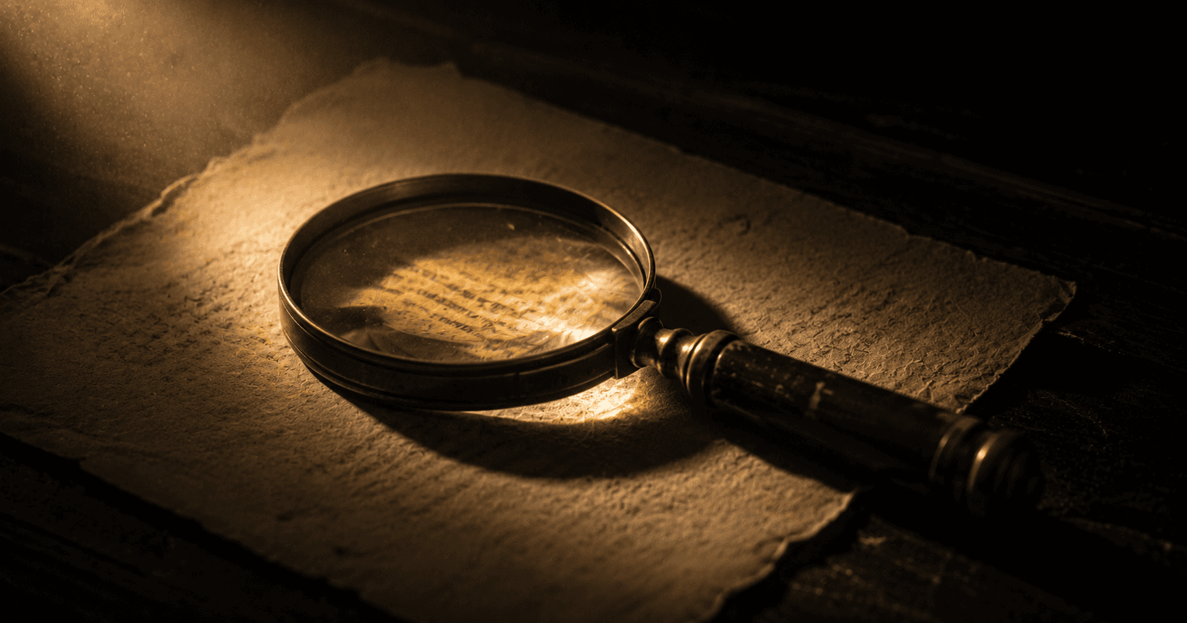 An antique brass magnifying glass resting on aged parchment, a warm-gold beam pooling through the lens — reading what is written and inferring what is not.